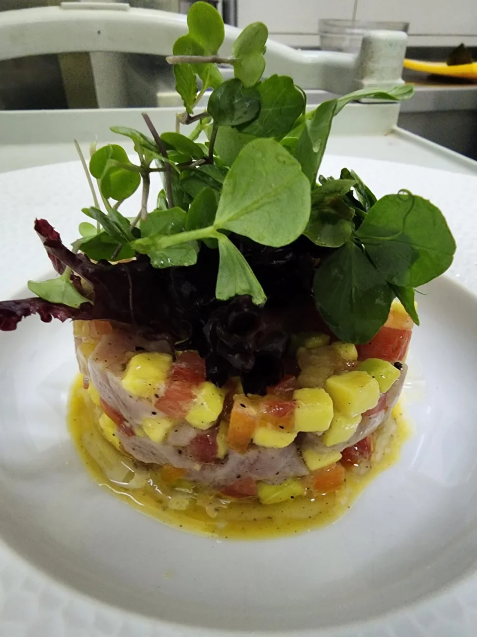 Layered starter topped with microgreens